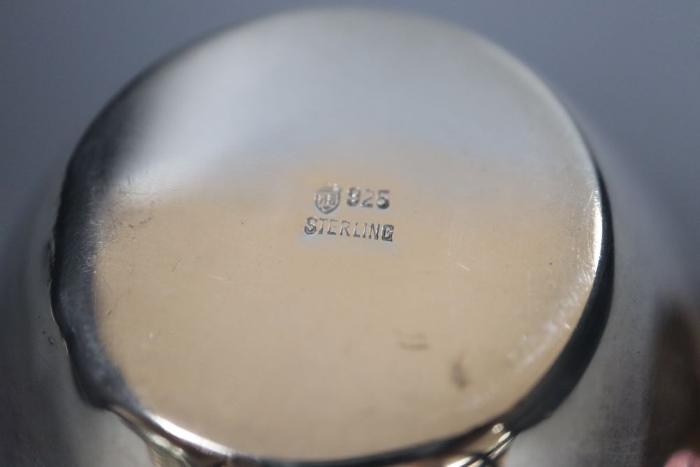 A small Persian white metal dish with inset coin, 67mm, a sterling small vase and a modern silver photograph frame.